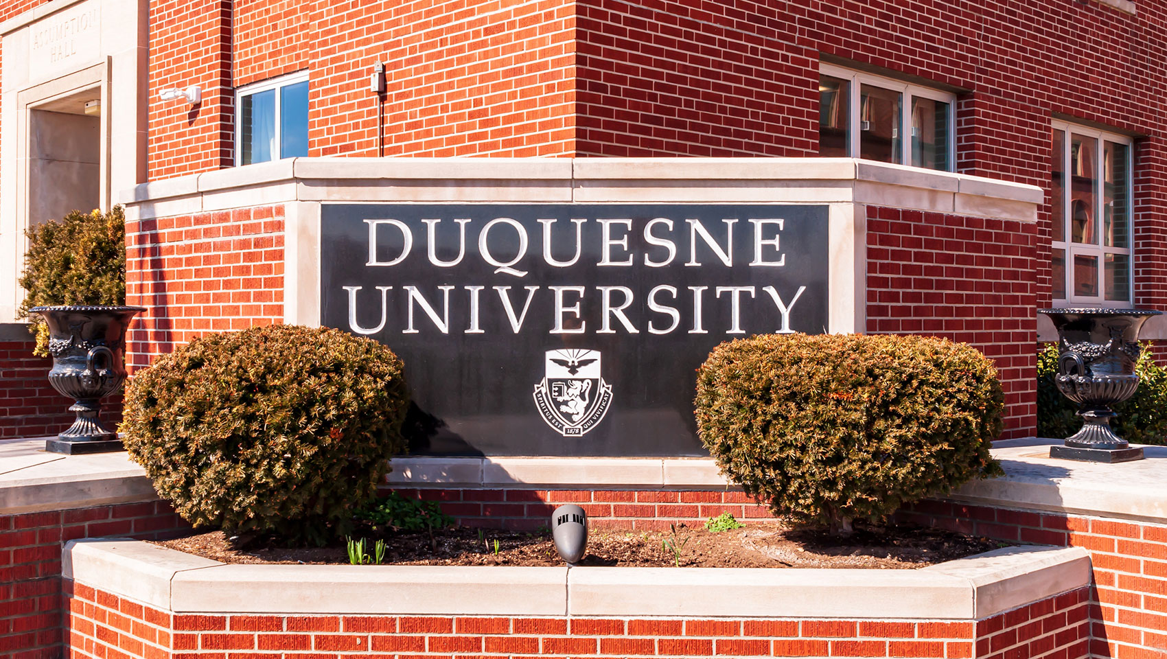 Duquesne University sign on a brick building