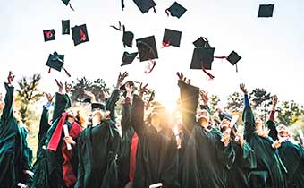 graduates throwing their caps in the air