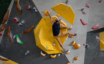 man climbing rock wall