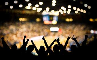 fans cheering in a basketball arena
