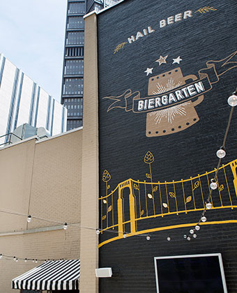 The Biergarten Rooftop Bar Pittsburgh Mural. Rooftop Biergarten with views of the city. Dangling Bulbs and outdoor TVs.