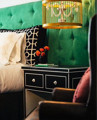 Kimpton Hotel Monaco Pittsburgh nightstand and chair details in guest room.