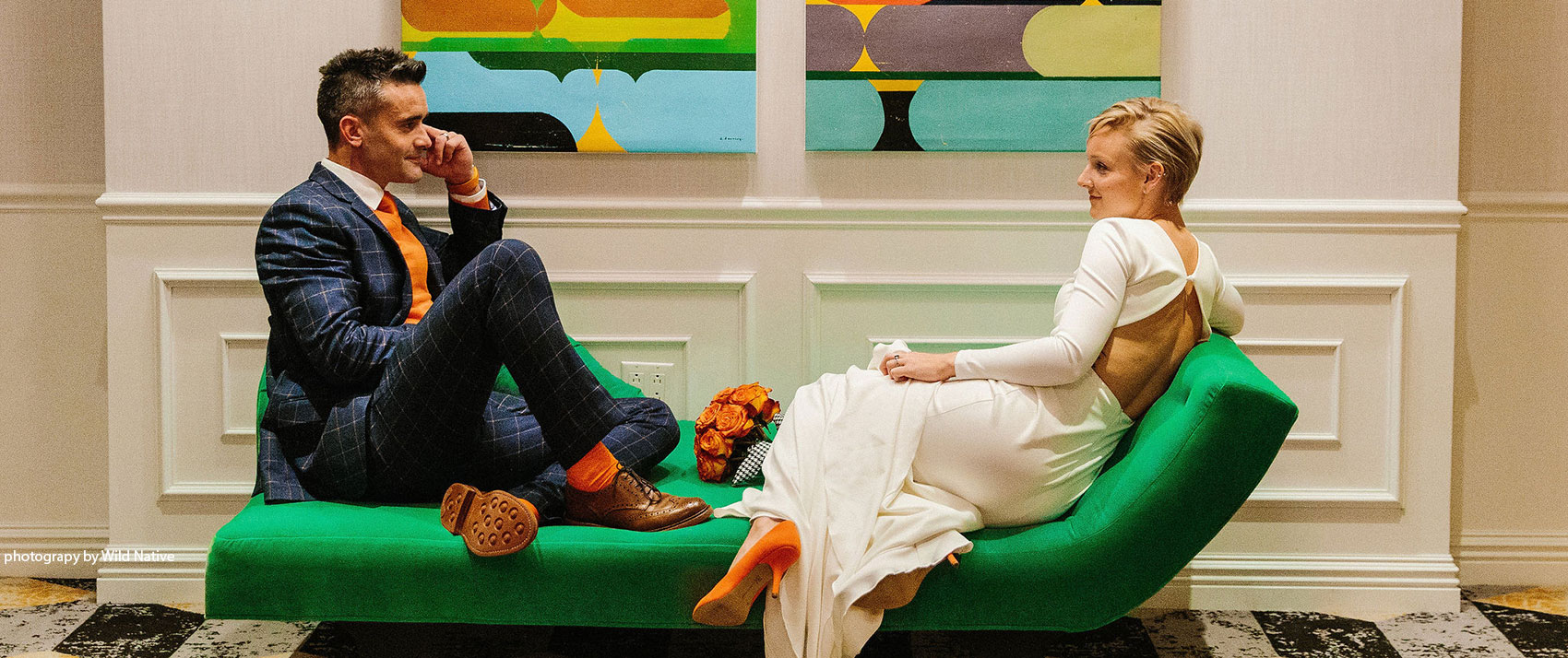 Two people sitting on green couch